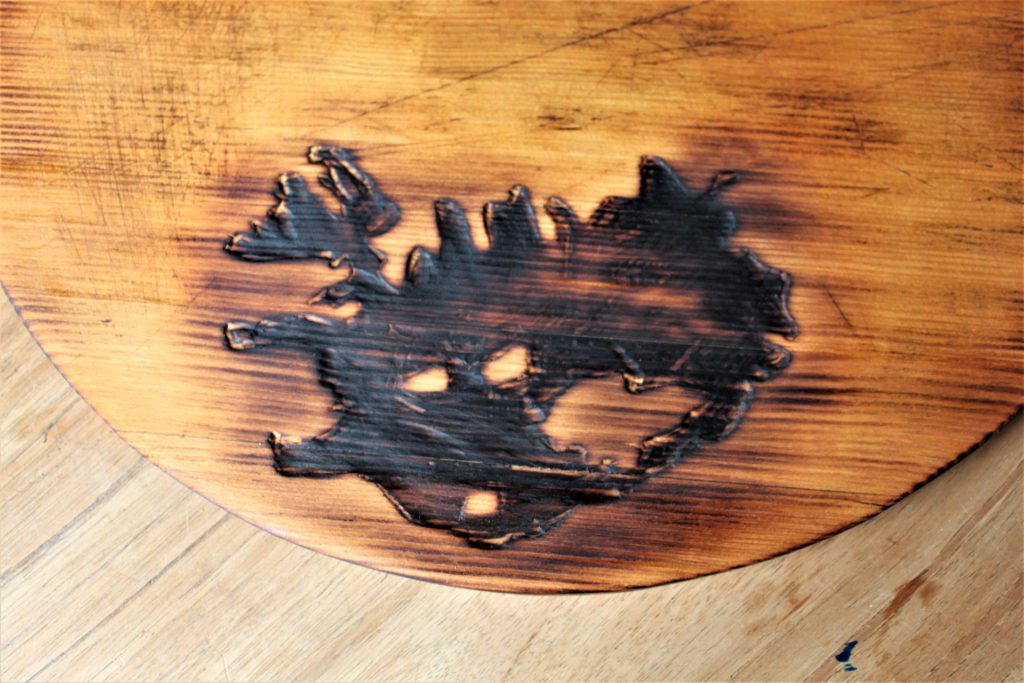 Burnt carving on an old wood tray